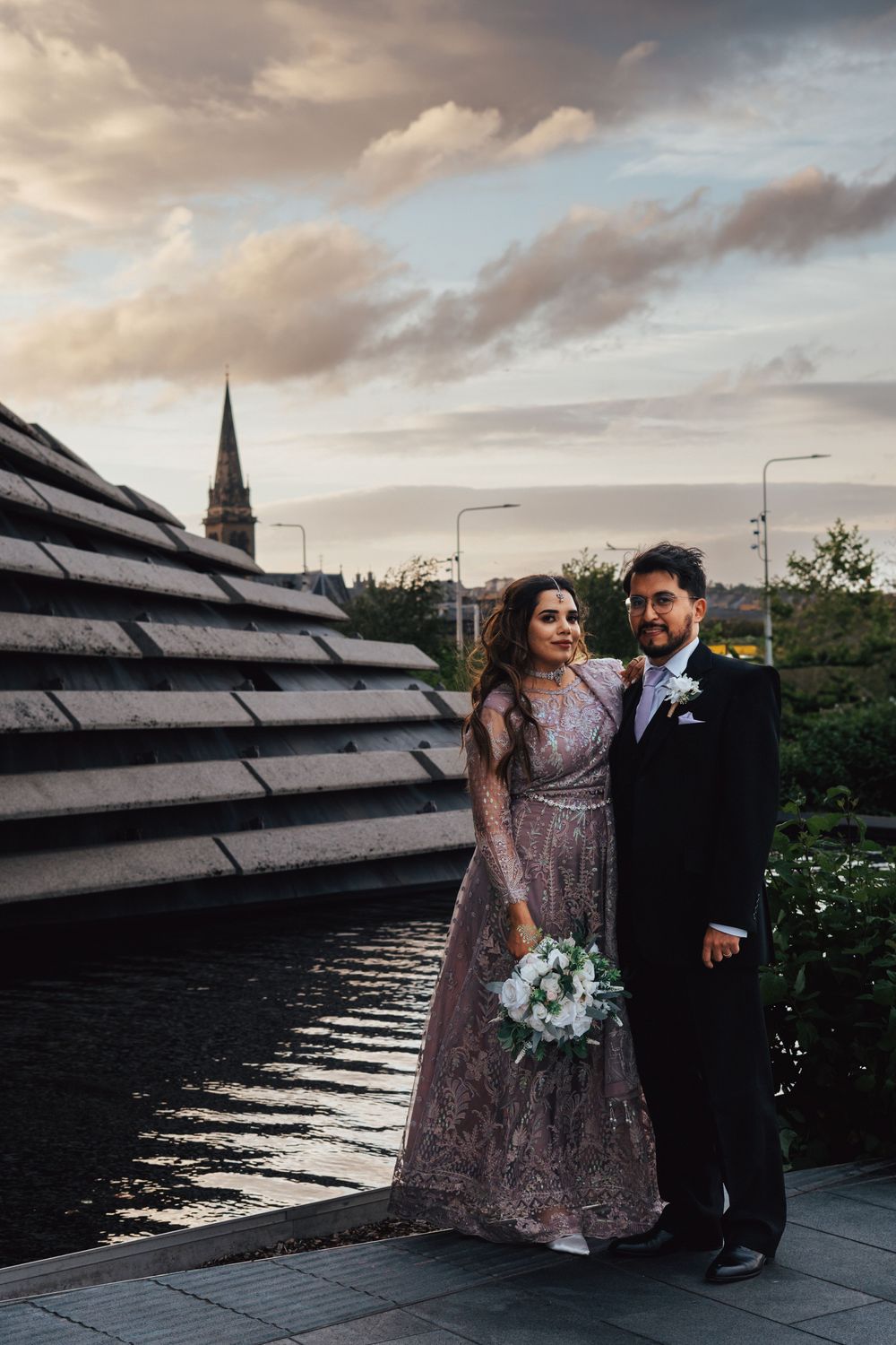 Bride and groom holding hands at sunset at the V&A in Dundee by Perthshire wedding photographer