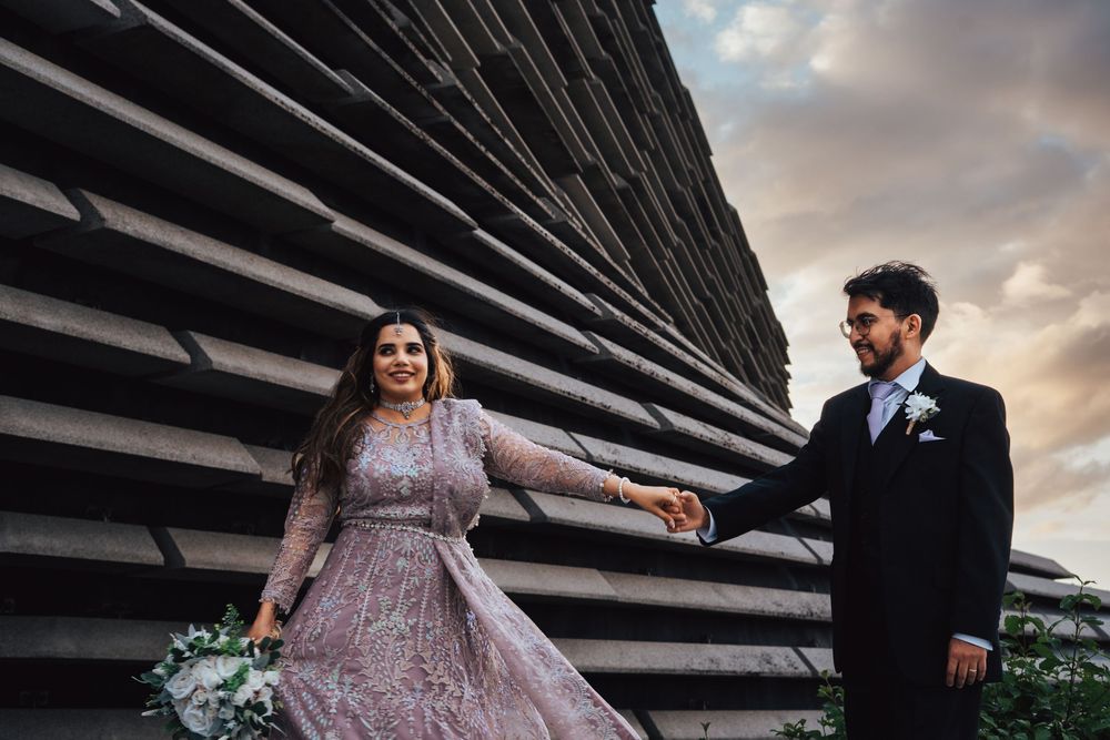 Bride and groom holding hands at sunset at the V&A in Dundee by Kinross photographer