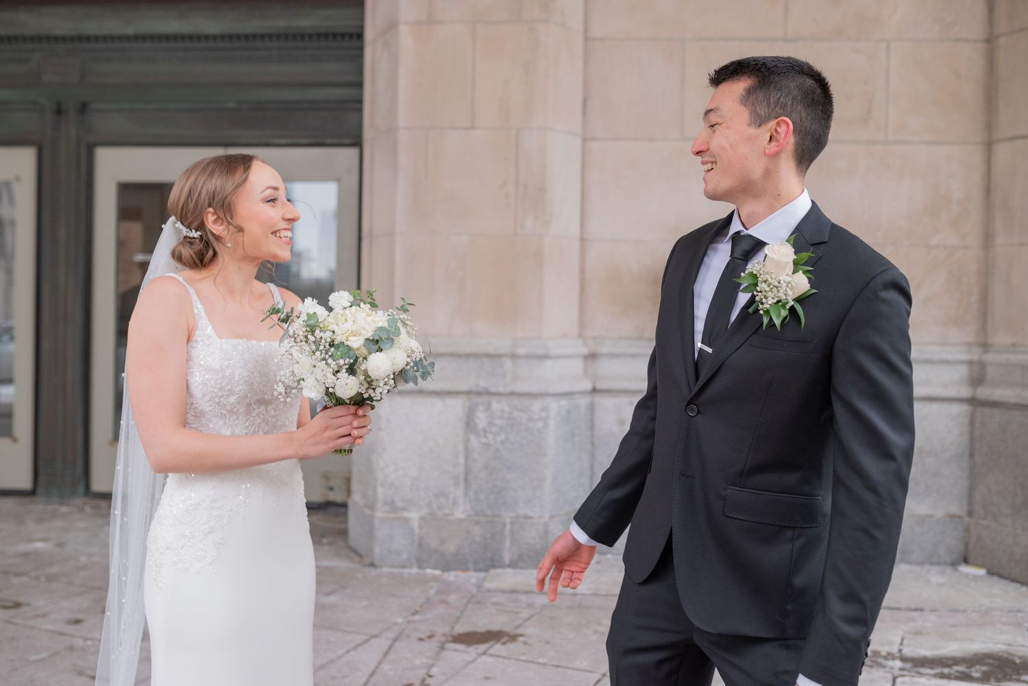 Bride and groom share joyful first look in front of Château Laurier in winter