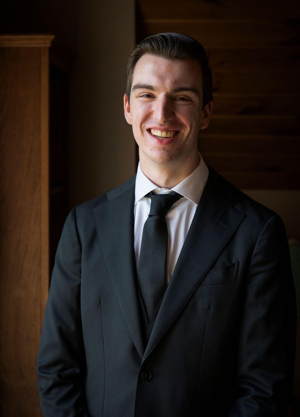 Professional portrait series showing formal attire against dark wooden background.