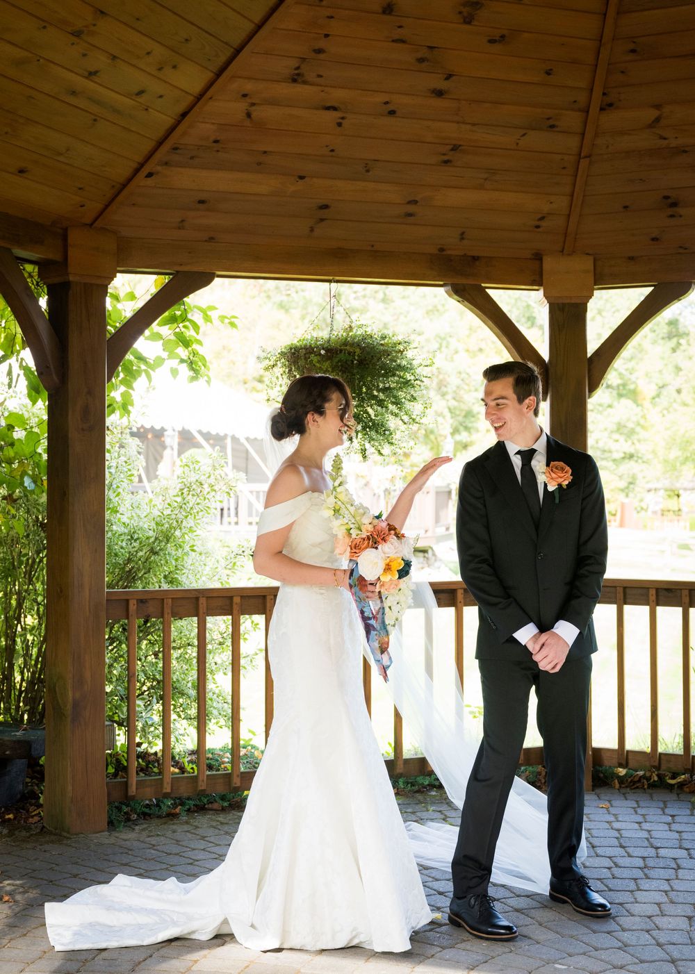 A romantic wedding photoshoot sequence under a rustic wooden gazebo with stone paving.