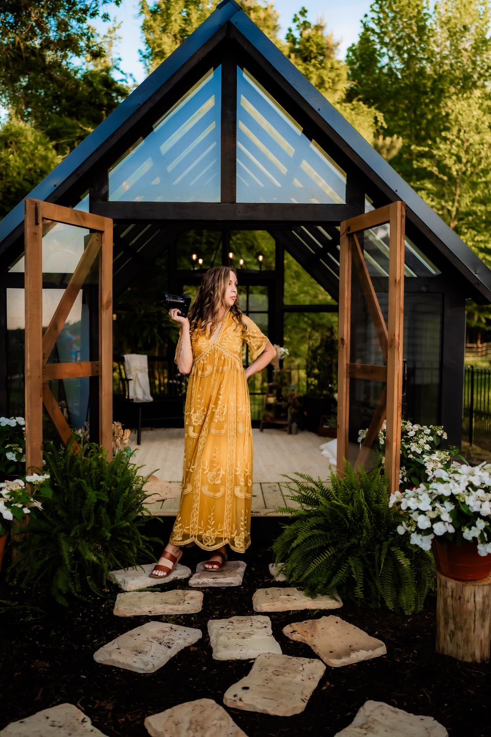 A yellow lace dress photographed in a series of outdoor poses near a wooden gazebo structure.