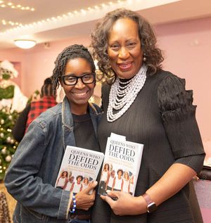 Pixs by Tina captured two ladies posing together holding the book which they both are contributing authors.
