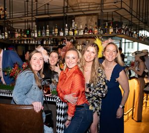 Pixs By Tina captures a large group of women celebrating The Kentucky Derby at the bar at a the Fitler club.