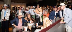 Pixs By Tina captures a large group of people celebrating The Kentucky Derby at the bar at the Fitler club.