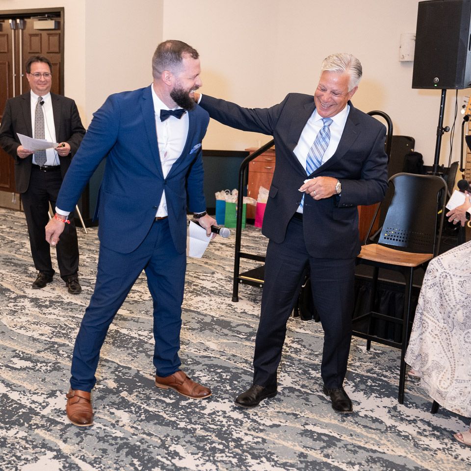 Pixs By Tina captures a two gentlemen congratulating each other during Edward Jones' award ceremony