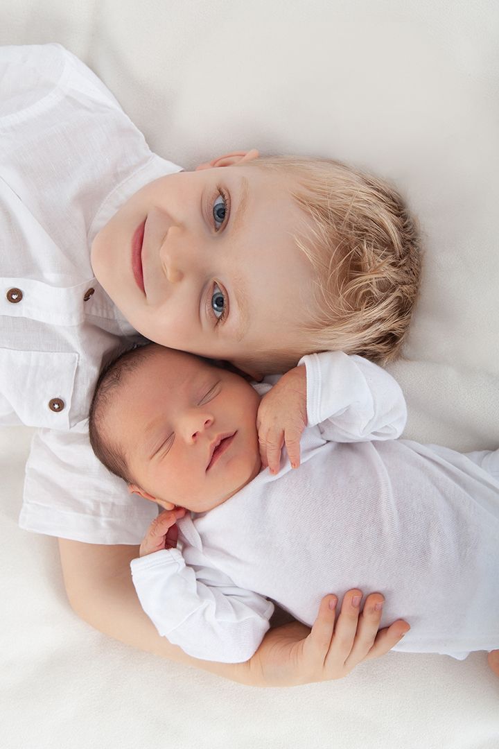A child in a white shirt lying on white bedding showing various gentle expressions in a composite photo series.
