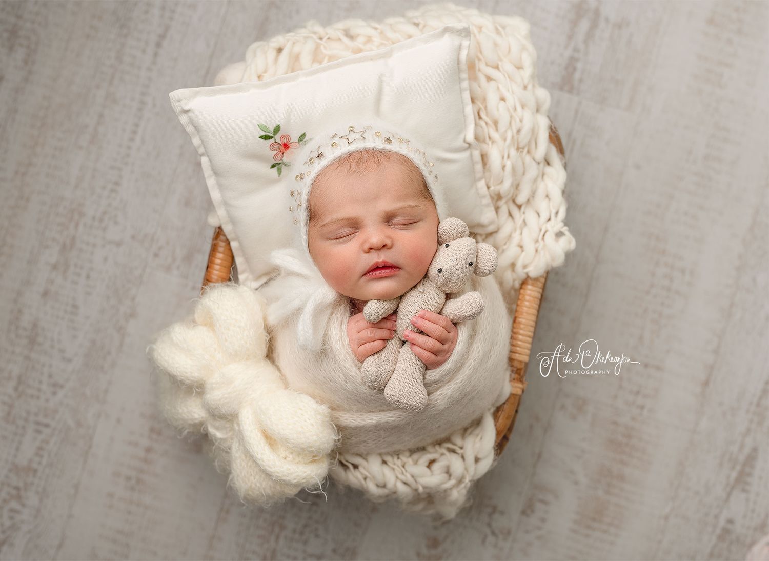 Swaddled newborn sleeping peacefully- A close up of a newborn baby wrapped in a soft, neutral-coloured wrap, peacefully sleeping.