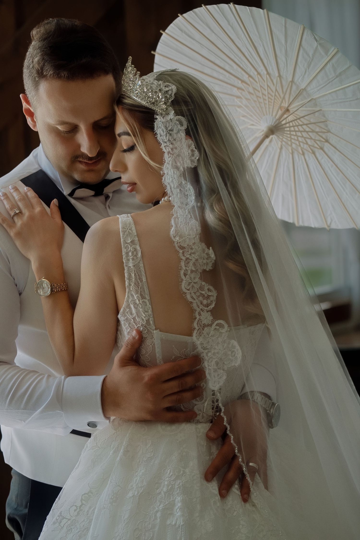 Close-up of hands with engagement ring during intimate romantic moment.