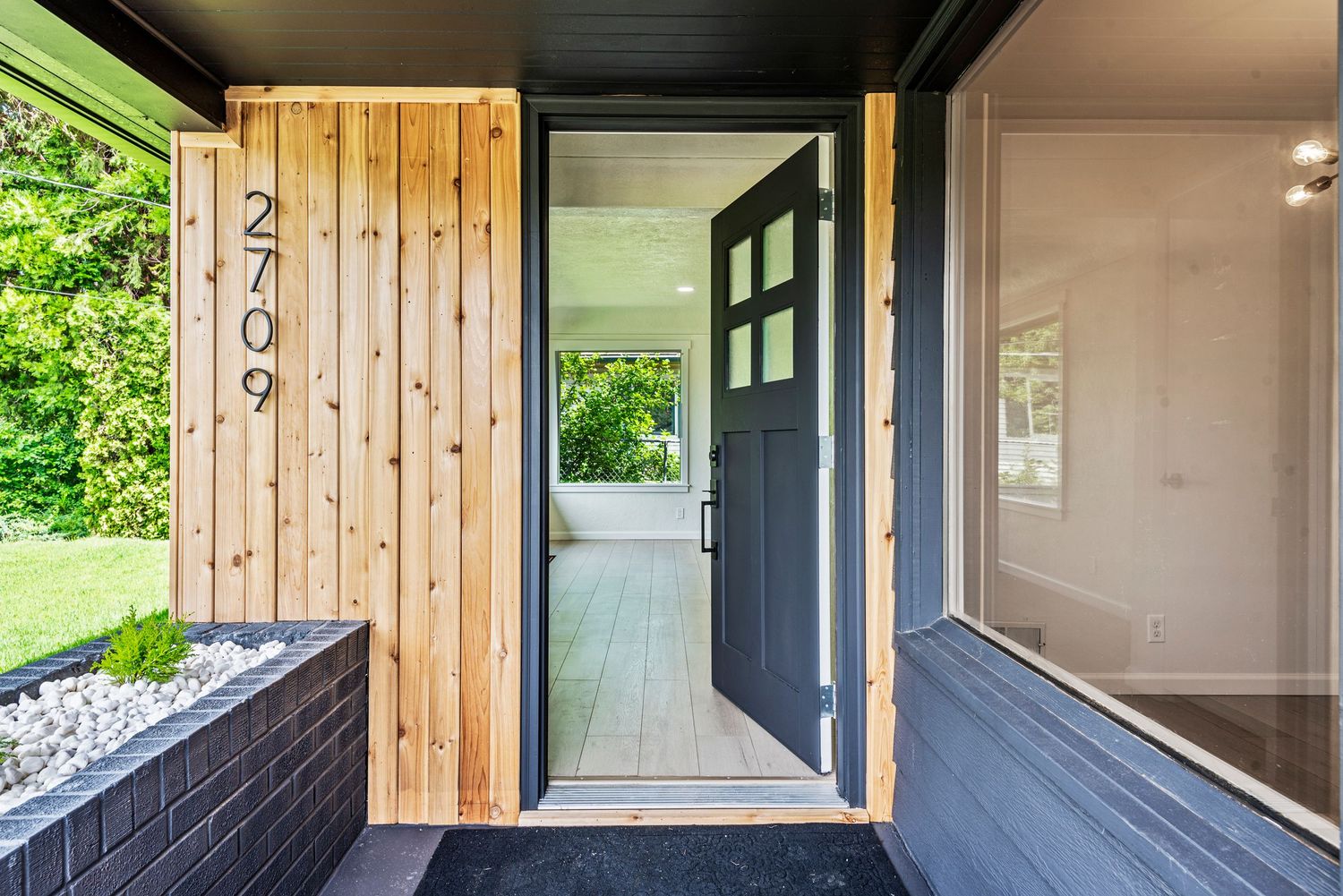 A modern doorway leading into a spacious living room