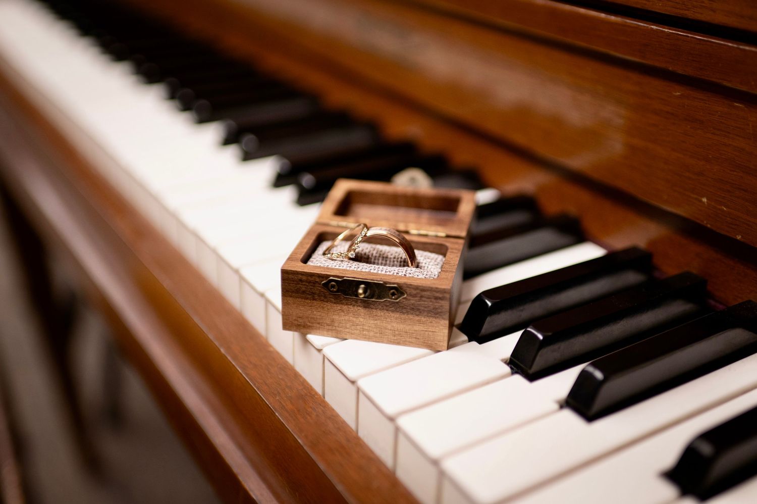 A set of rings on a piano at a wedding