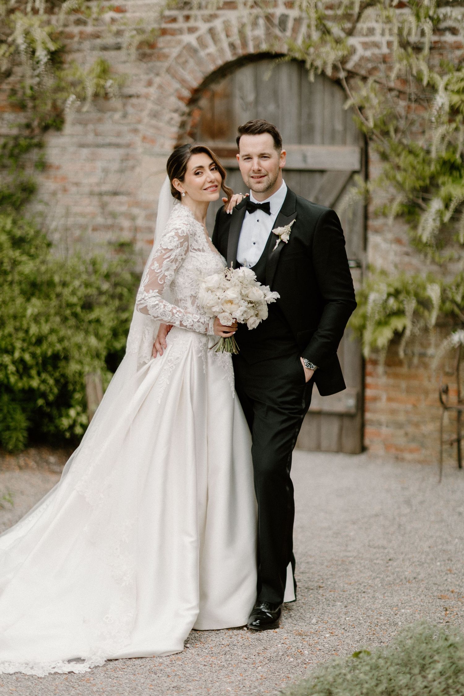 Ethereal wedding gown featuring delicate corset bodice and dramatic sheer puff sleeves.