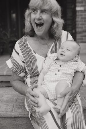 Black and white portrait series showing playful moments between grandmother and baby.