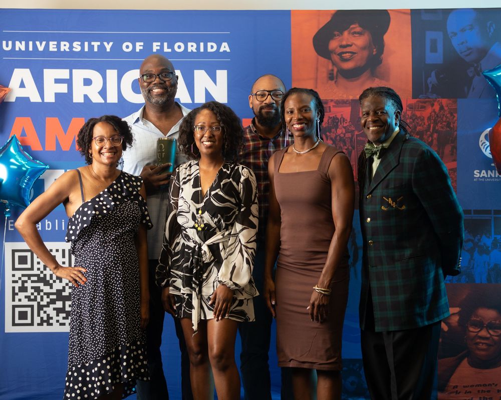 Group photo at University of Florida African American Studies event against blue and orange branded backdrop.