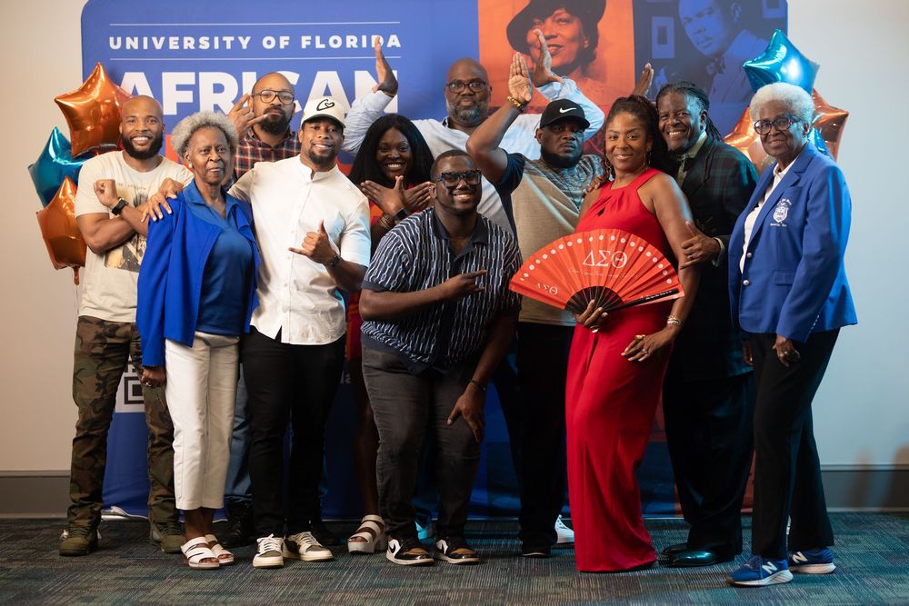 Large group poses together at University of Florida African American Studies event wearing formal attire.