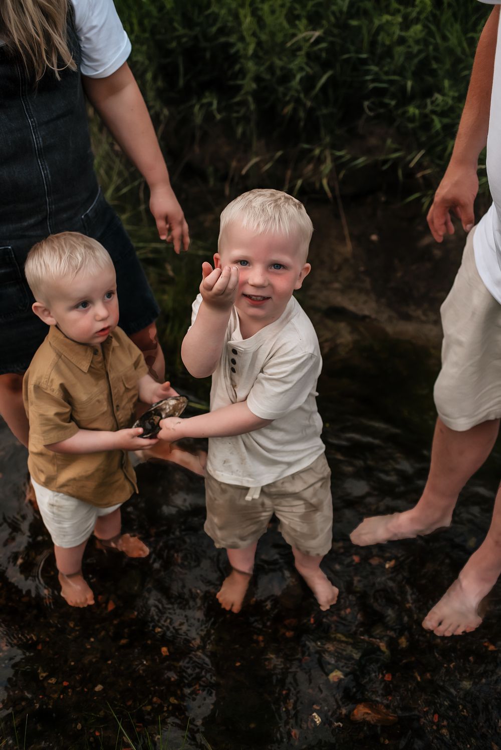 Lifestyle documentary photography session - looking for rocks with brother in the river - serving southwest North Dakota