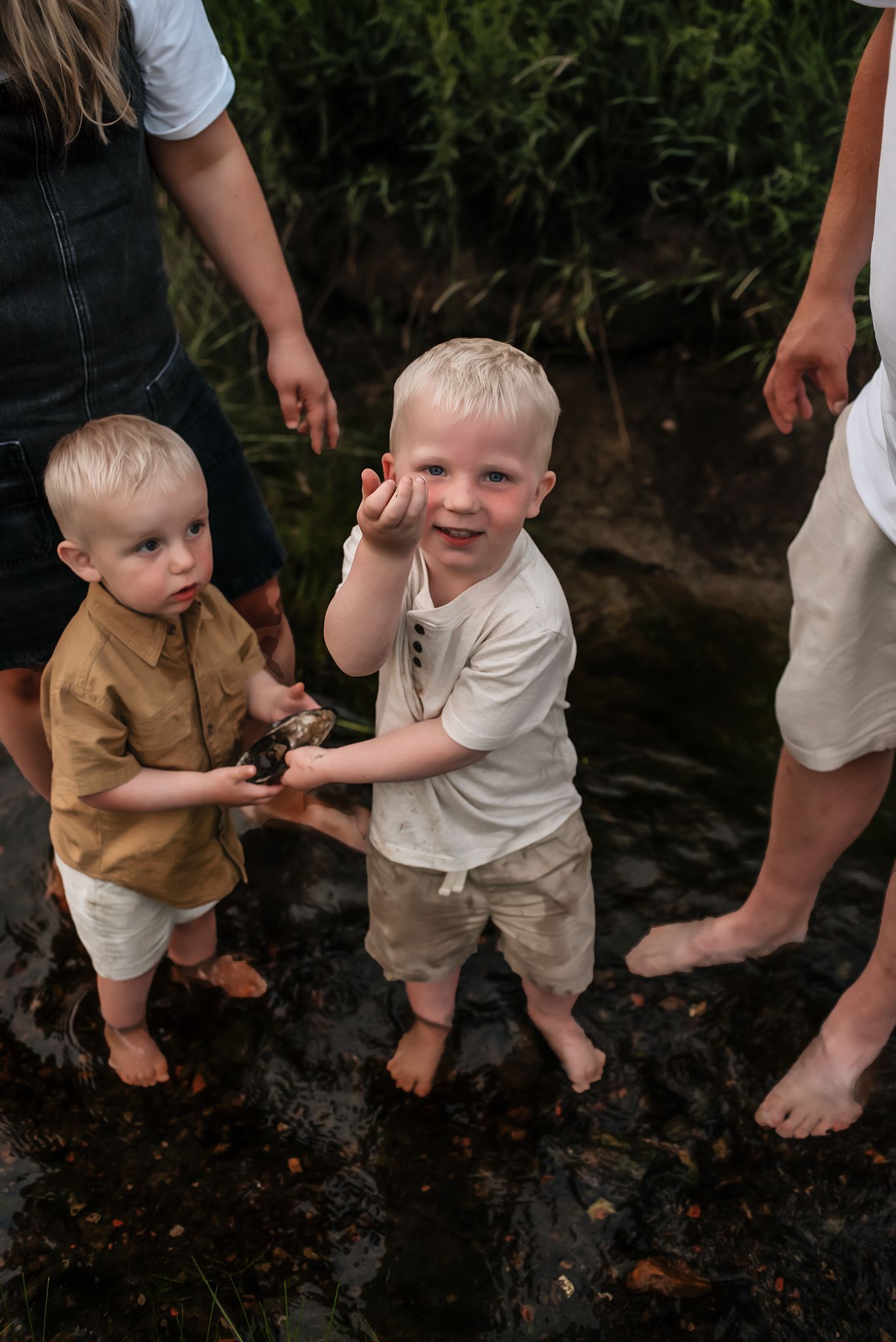 Lifestyle documentary photography session - looking for rocks with brother in the river - serving southwest North Dakota