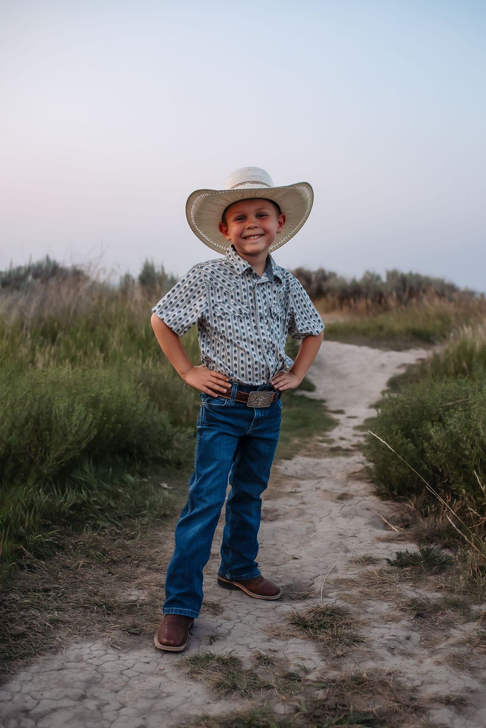 little cowboy posing during a family photography session in Theodore Roosevelt National Park - lifestyle photographer serving Medora, ND