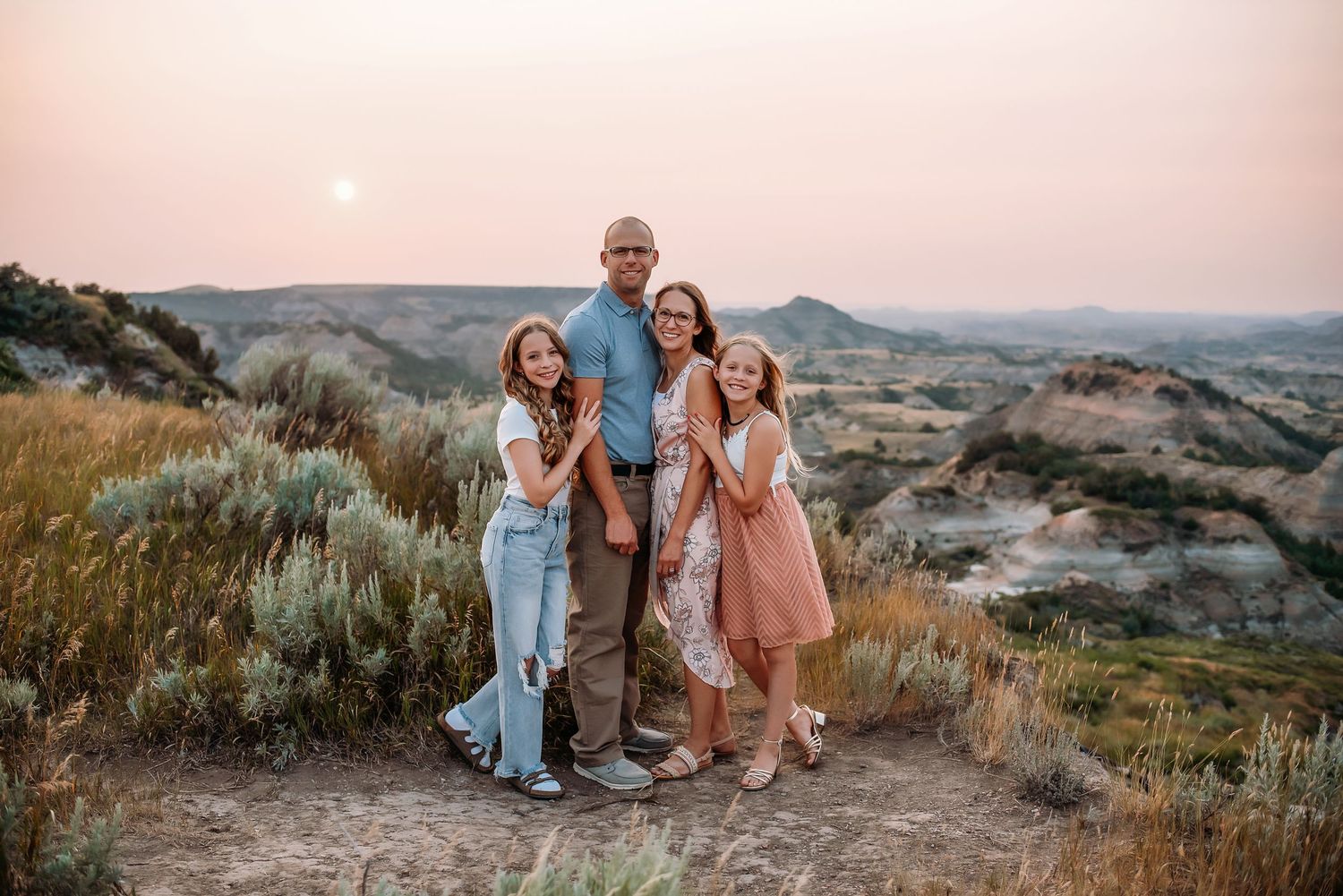Family posed at Painted Canyon, Medora, ND - lifestyle family photographer serving southwest North Dakota