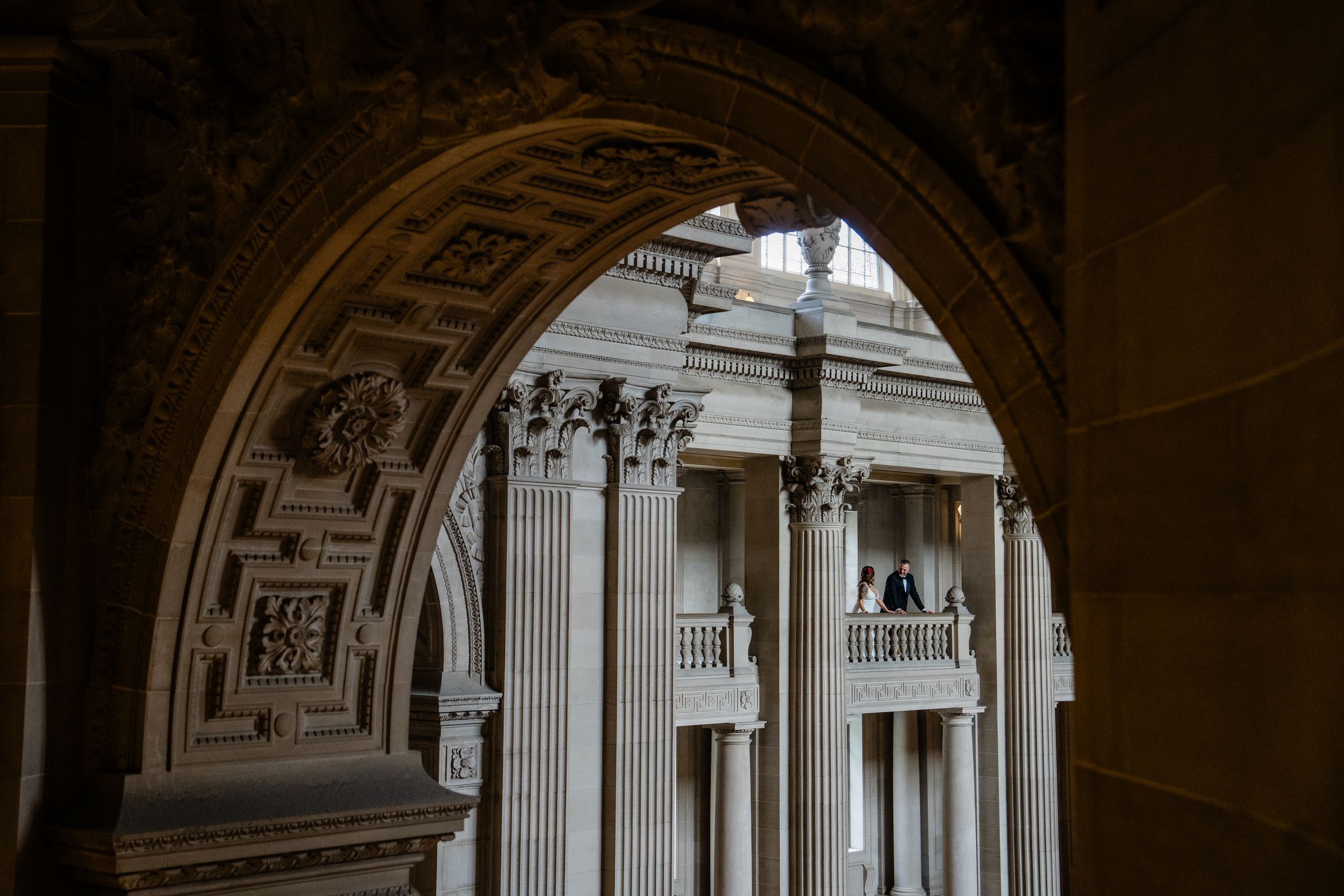 Architectural detail of ornate marble columns and arches in a historic building interior.