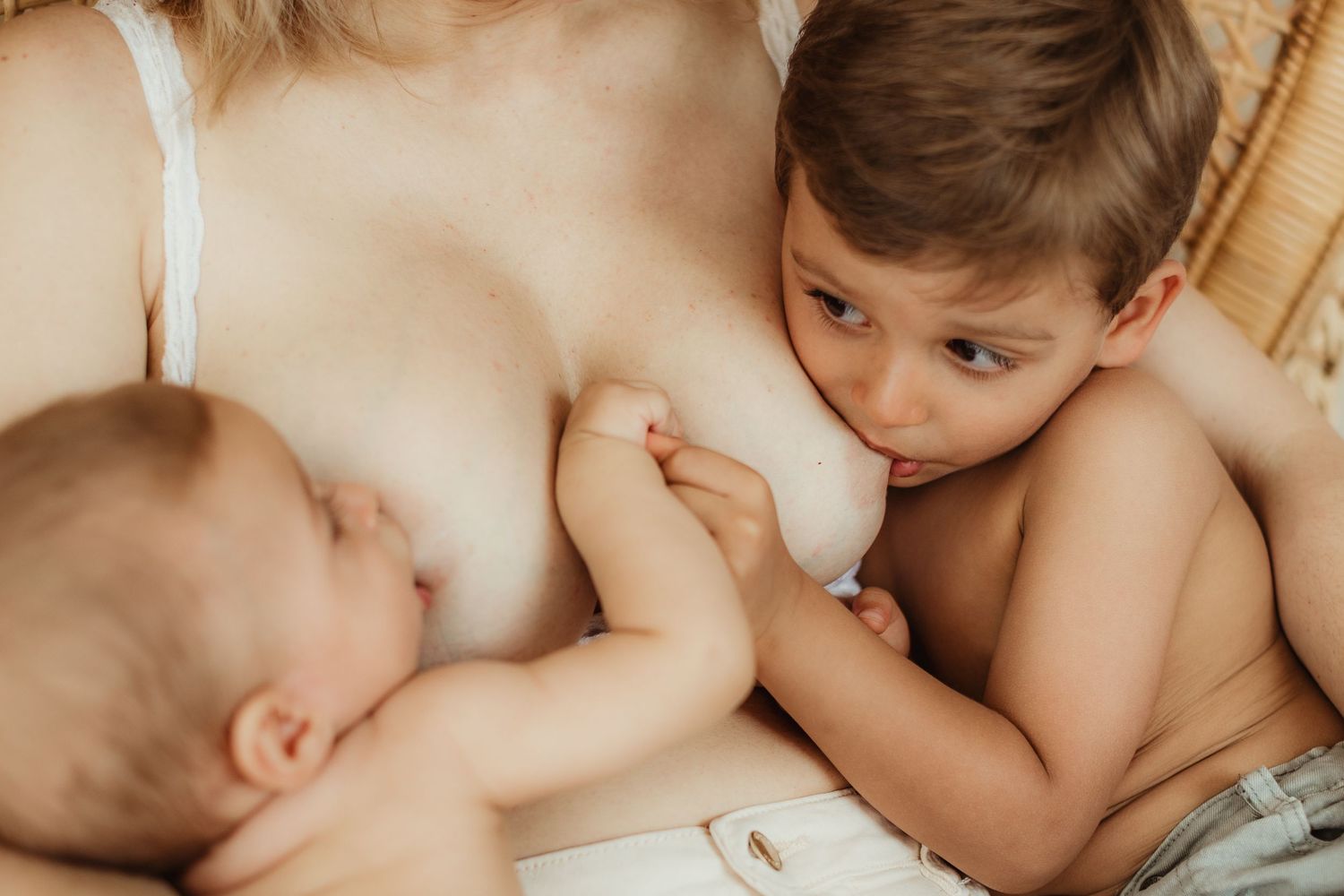 Intimate lifestyle photography capturing nurturing moments between parent and child.