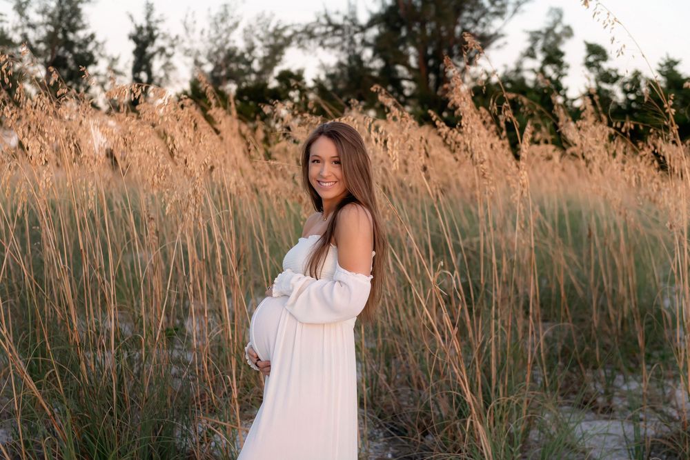 Tall grass sways in golden sunlight during sunset at a natural outdoor location.