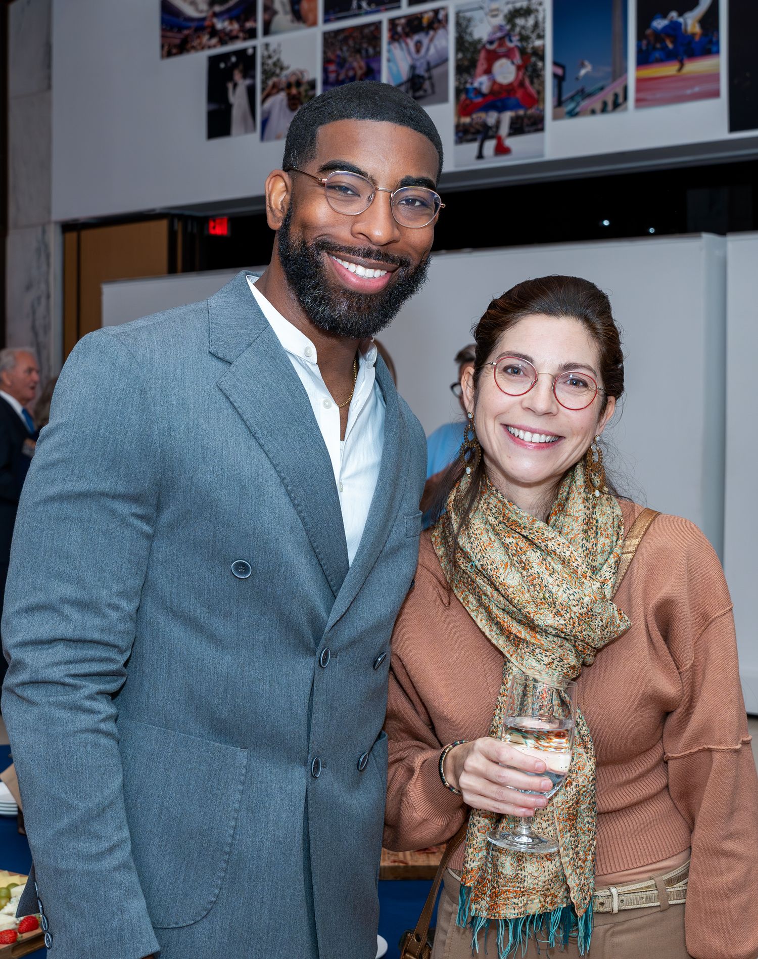 Professional duo in business attire sharing conversation at networking event.