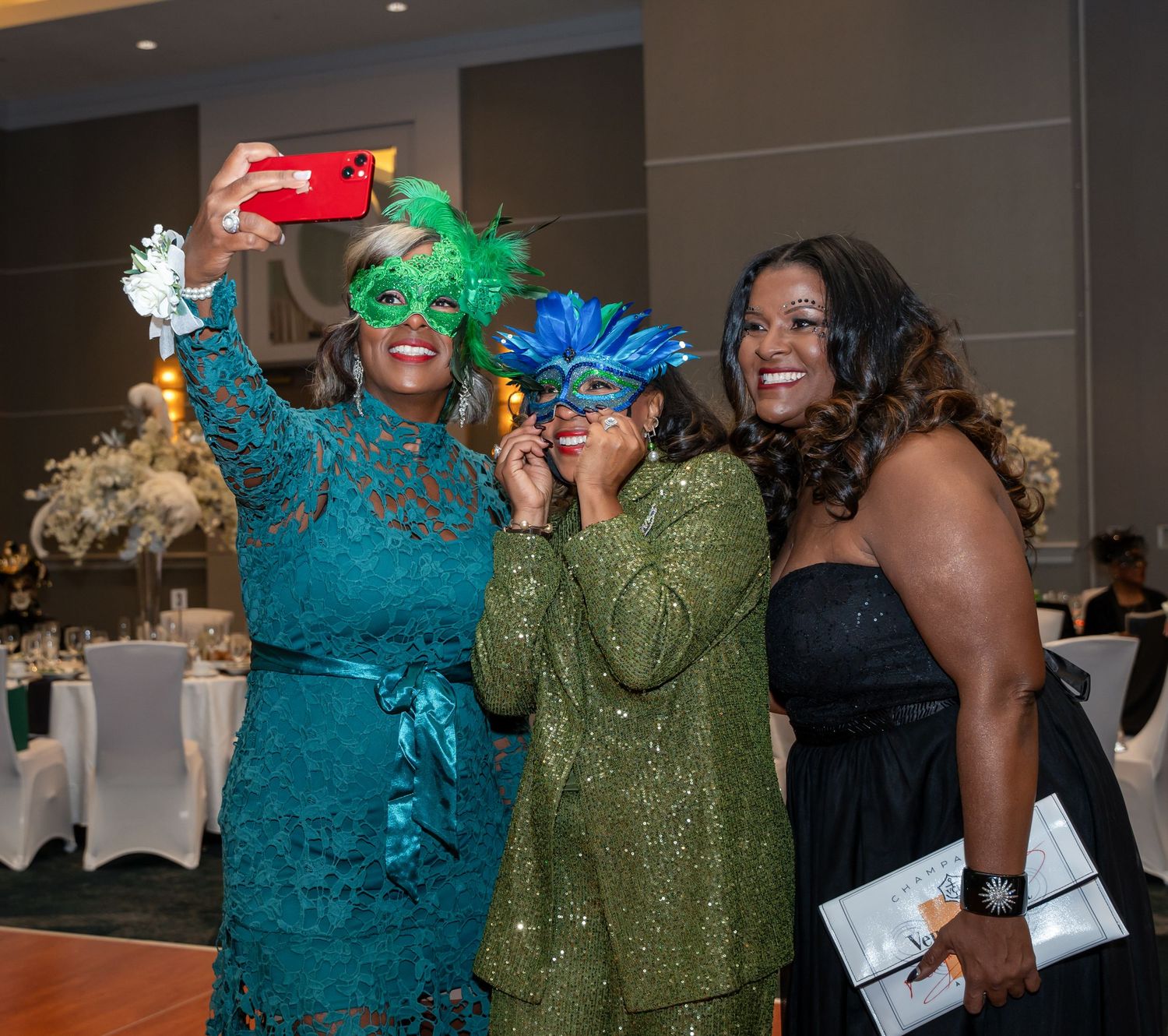 Celebratory gathering with guests in formal attire posing for photos.