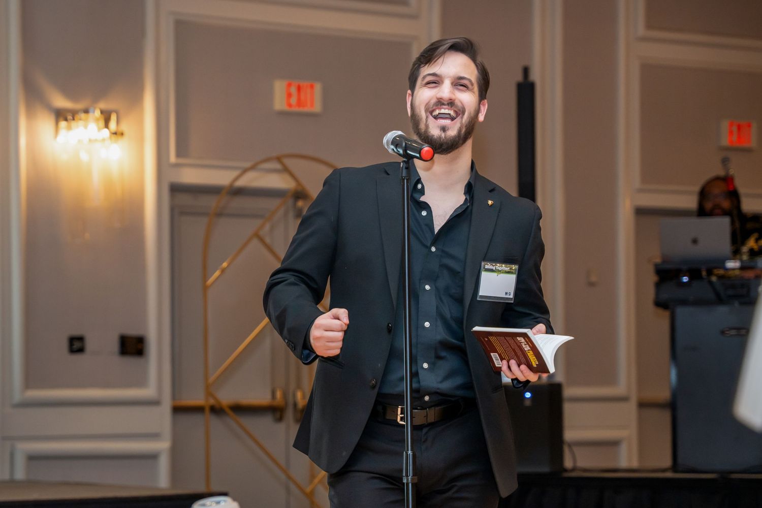 Speaker engaging with audience from podium at corporate event venue.