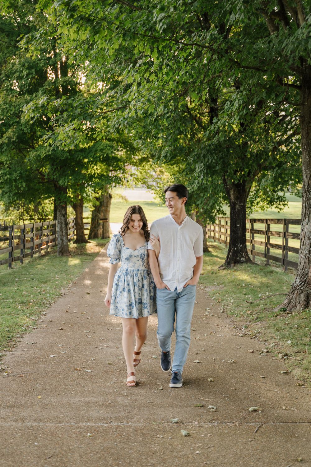 Engaged couple walking side by side in nature