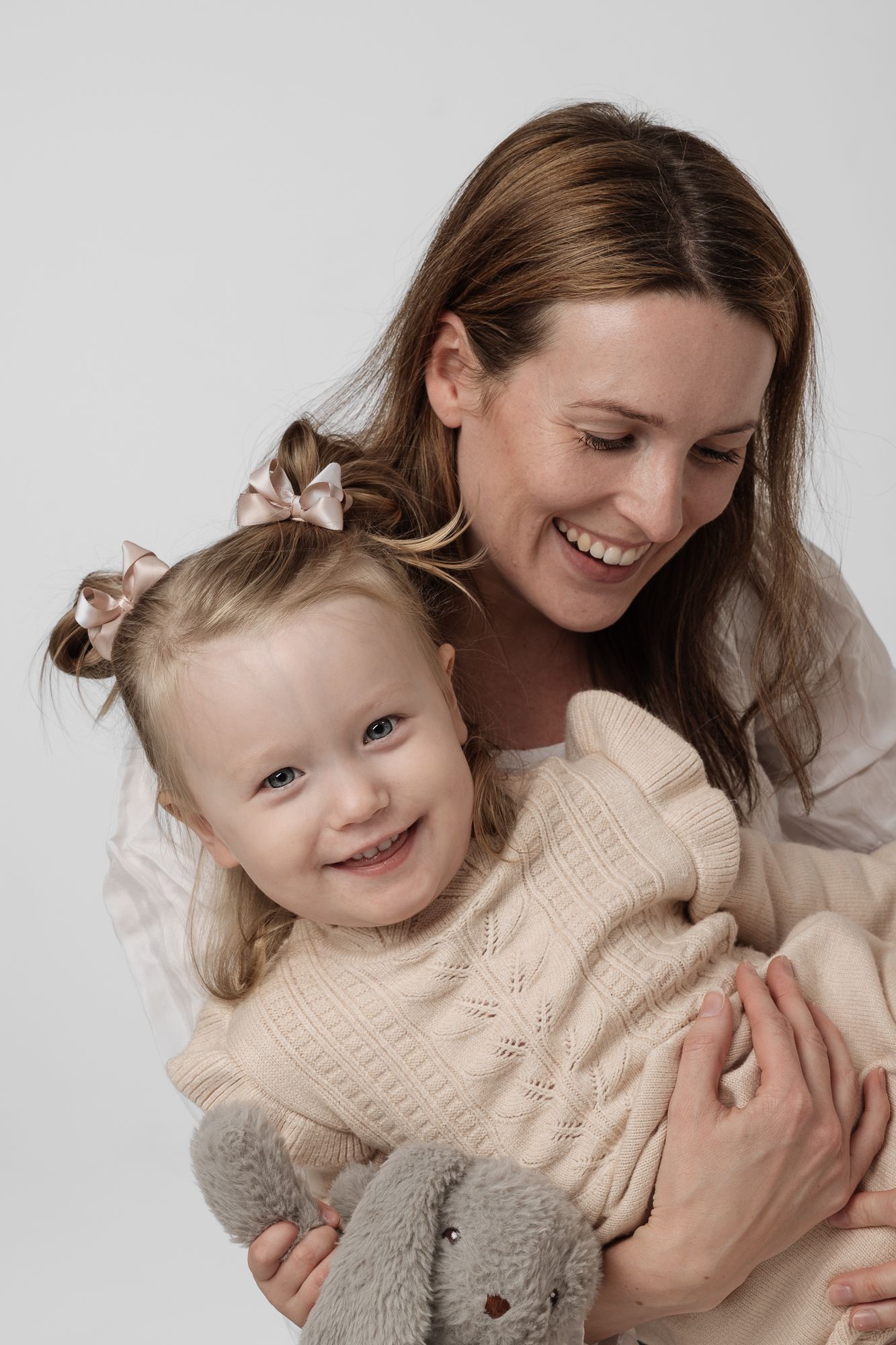 A joyful parent and child share tender moments of laughter and cuddles in a series of sweet photos.