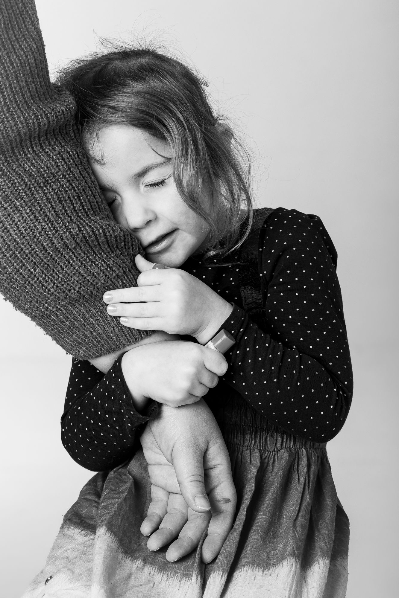 Black and white portrait of child hugging