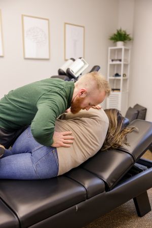 Limitless chiropractic in Sumner WA, man adjusting woman for lifestyle branding photo