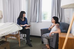 Maple Valley Acupuncture client intake with female therapist acupuncturist talking during intake of client before treatment session branding