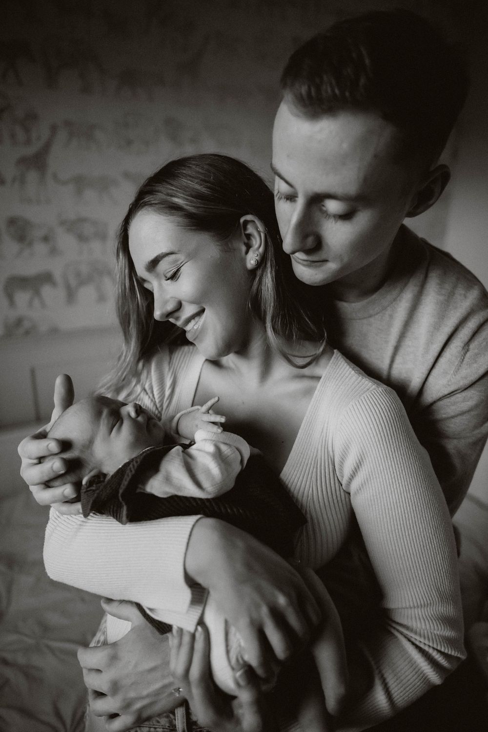 A couple embraces intimately in a series of romantic black and white photographs showing tender moments together.