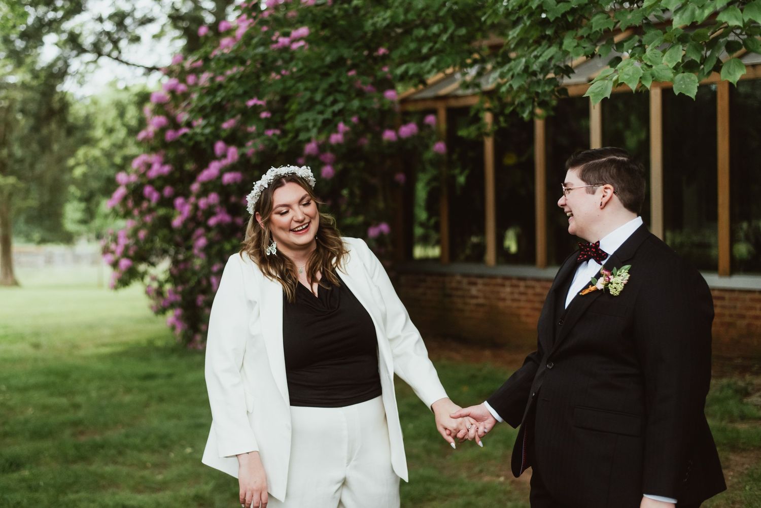 Queer couple holding hands on their wedding day in Durham North Carolina