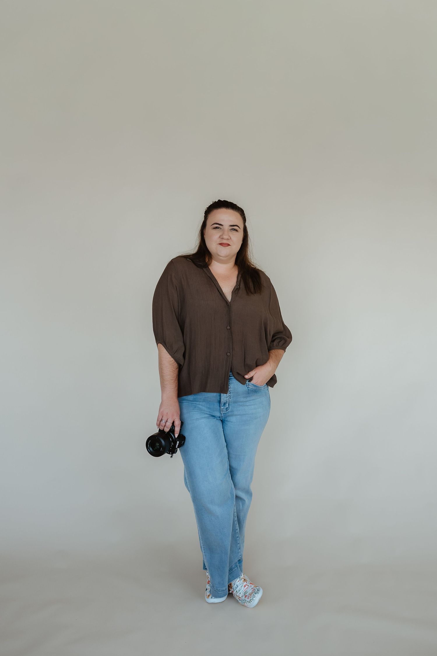 Casual portrait session against minimal grey background in gladstone studio setting.