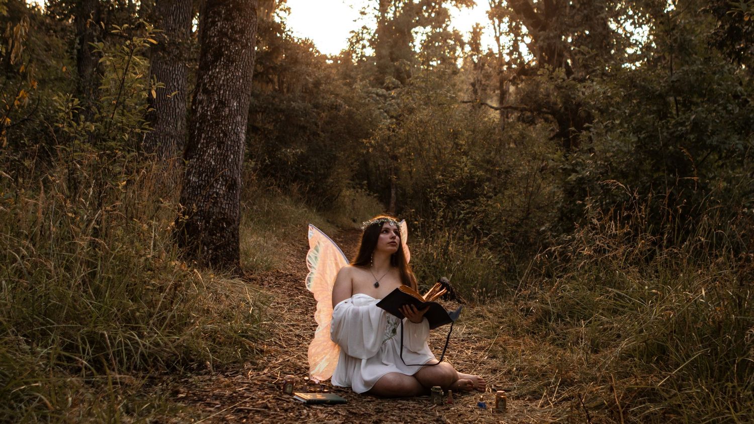 Young model dressed in white as a fairy in the woods near Eugene