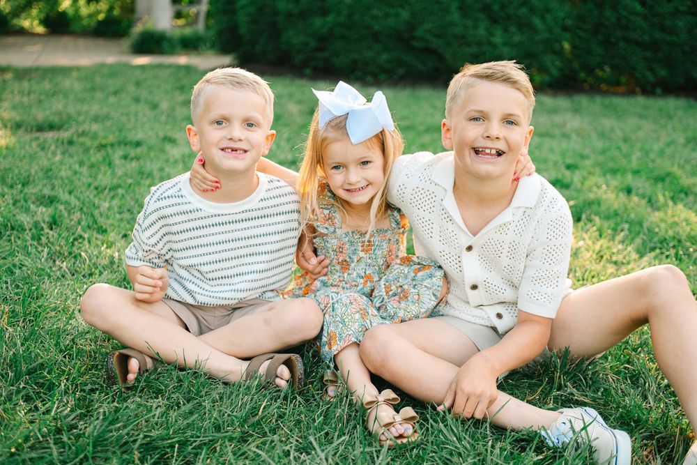 A collage of outdoor family portraits taken in a lush green park setting during a sunny summer day.