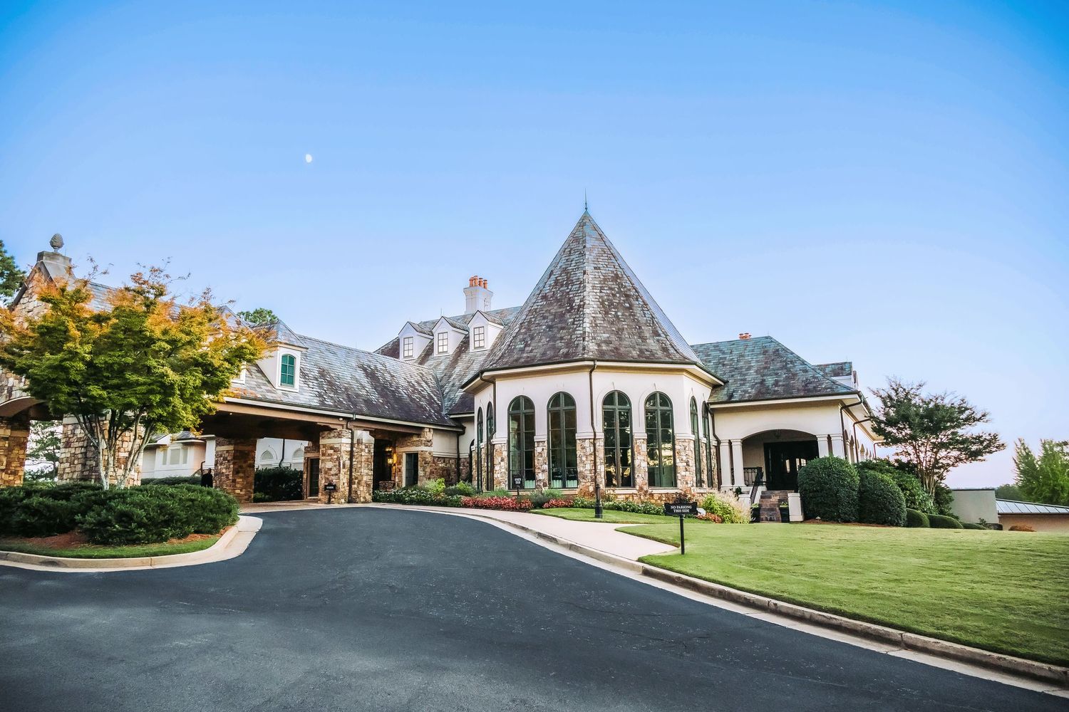 Elegant chapel-style building with circular driveway and manicured lawn.