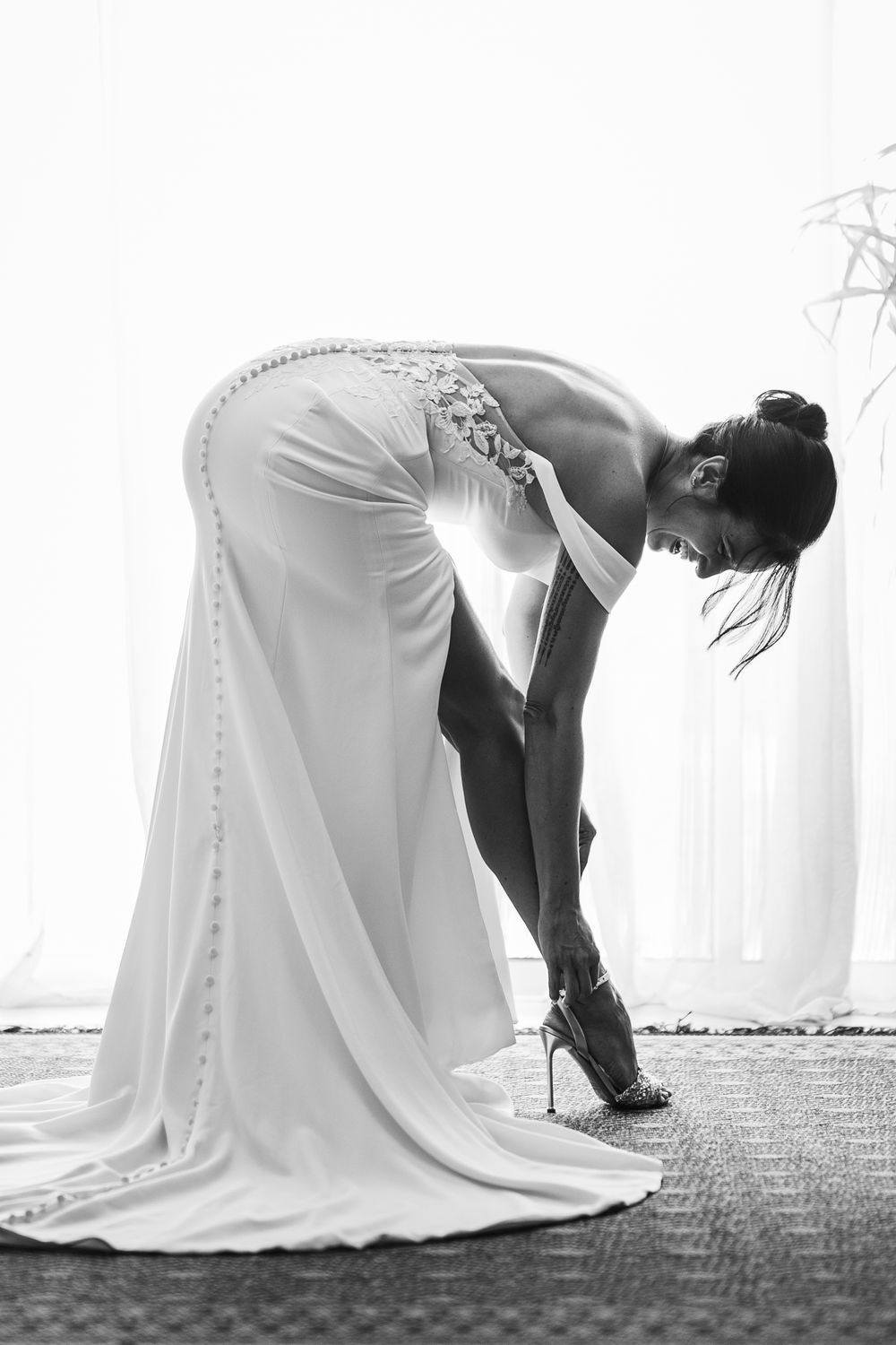 A sequence of dance movements showing a figure in white fabric bending and flowing through graceful positions.