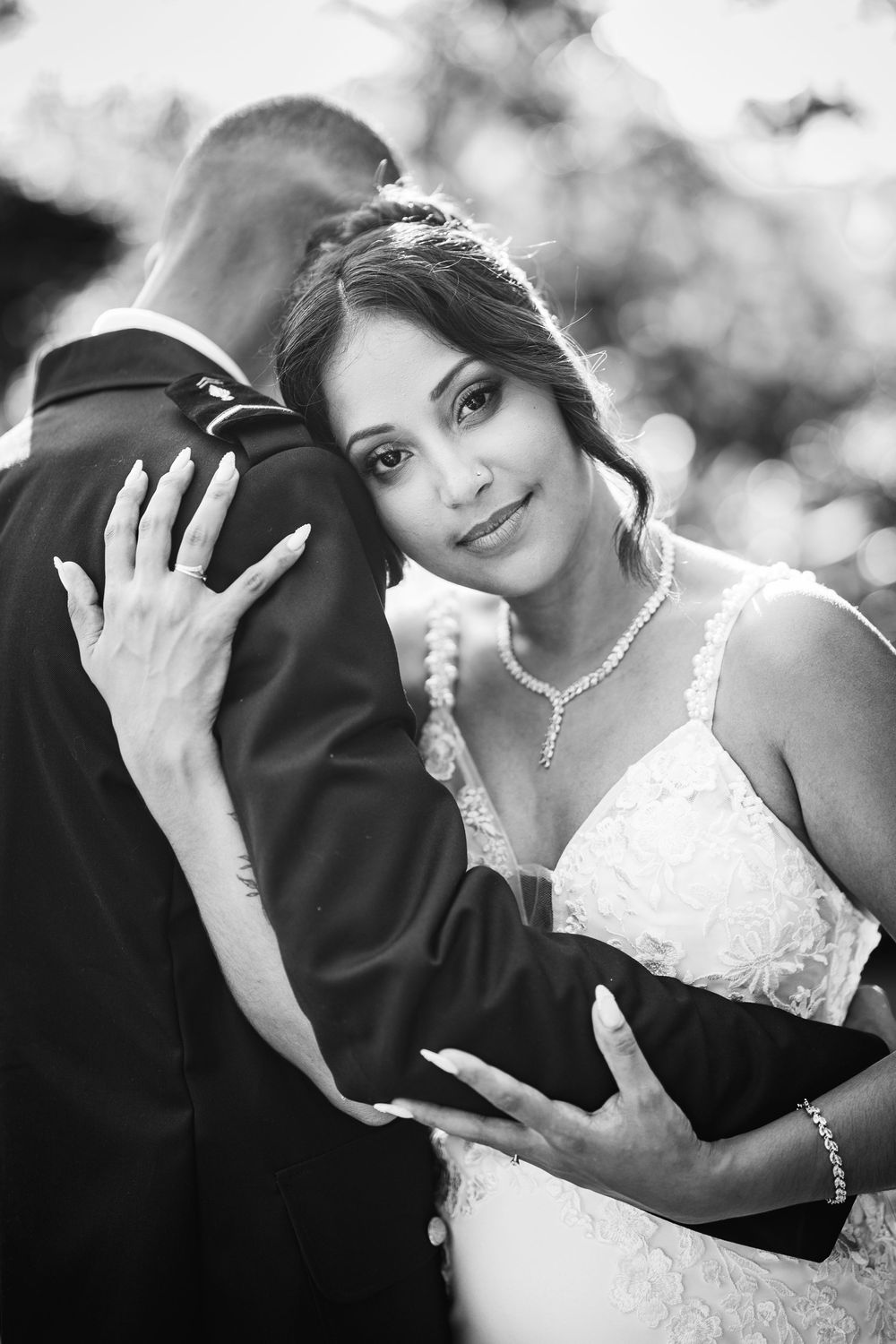 Black and white wedding photo series showing romantic moments between a bride and groom in close-up portraits.