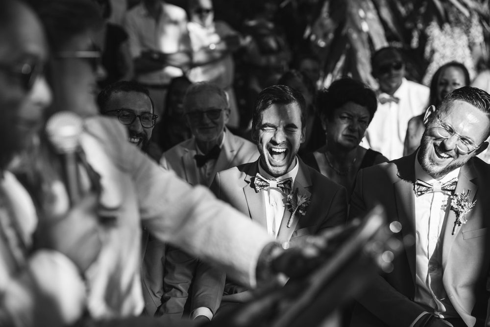 Black and white photo capturing celebratory moments at a formal wedding reception.