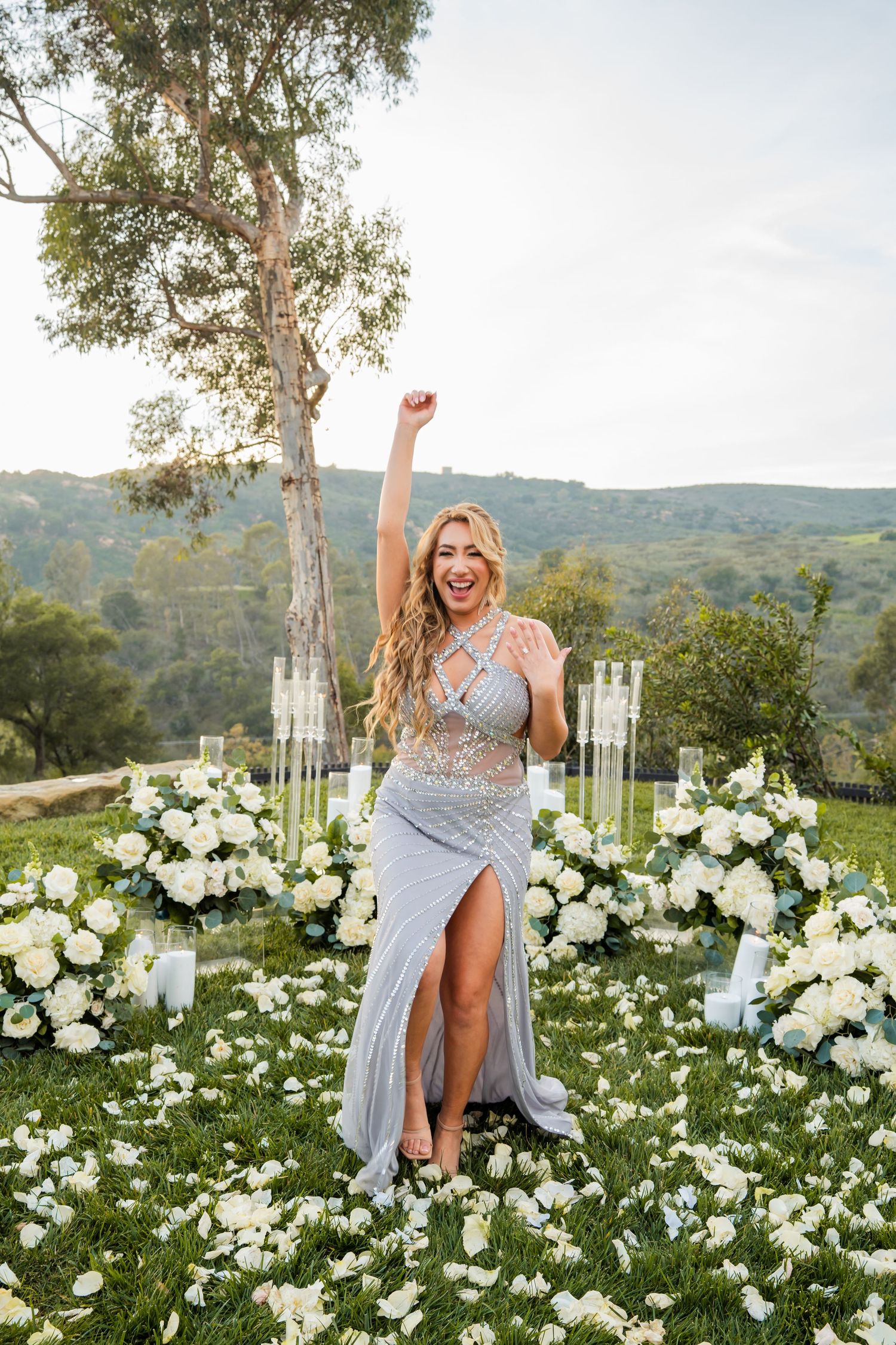 A glamorous outdoor photo session among white flowers with rolling hills in the background.