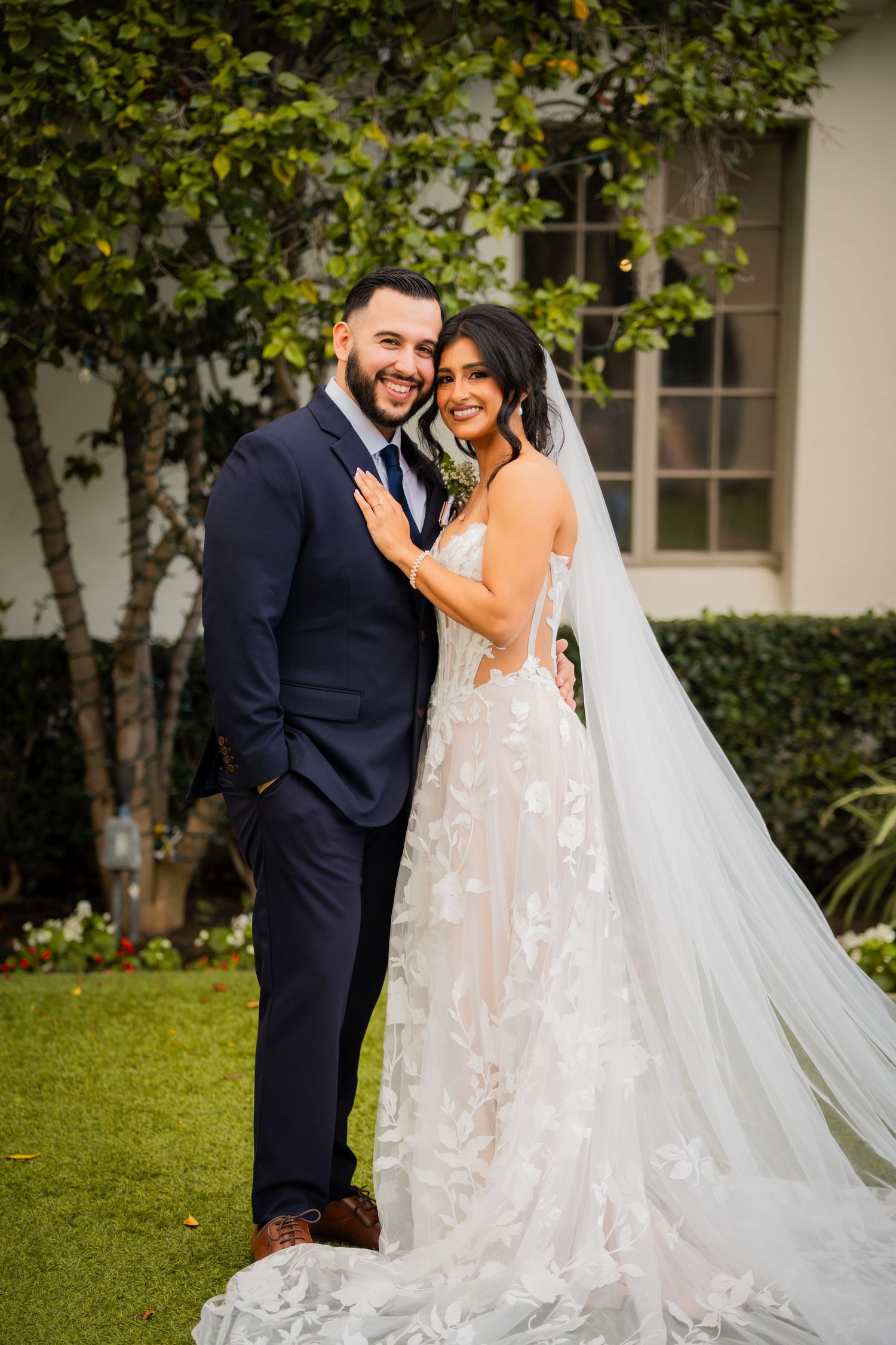 Romantic wedding couple sharing a moment together in a garden setting.