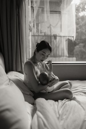 A black and white photo series showing a person sleeping peacefully in bed with soft morning light through the window.