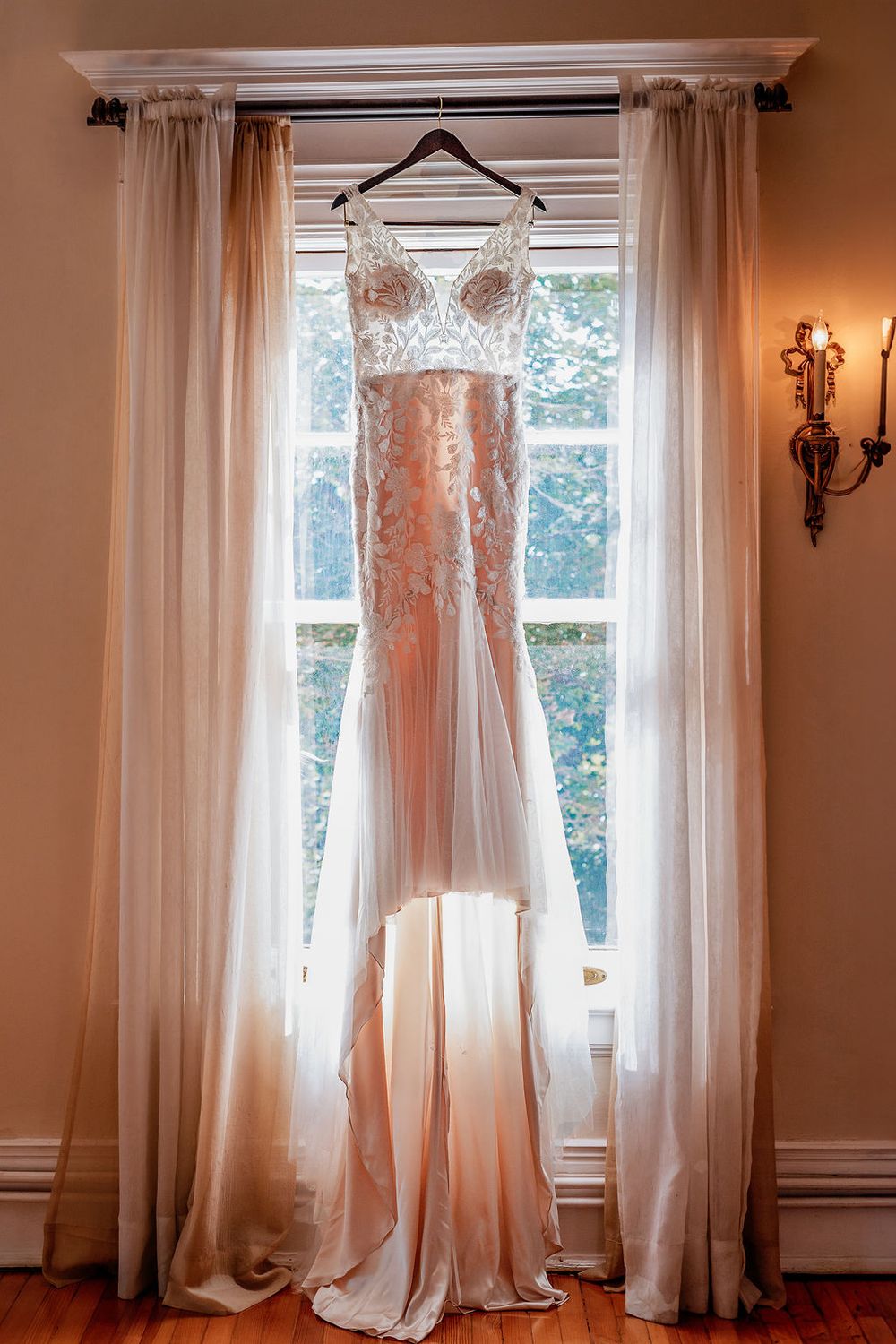wedding dress hanging in the grant Humphreys mountain bridal window