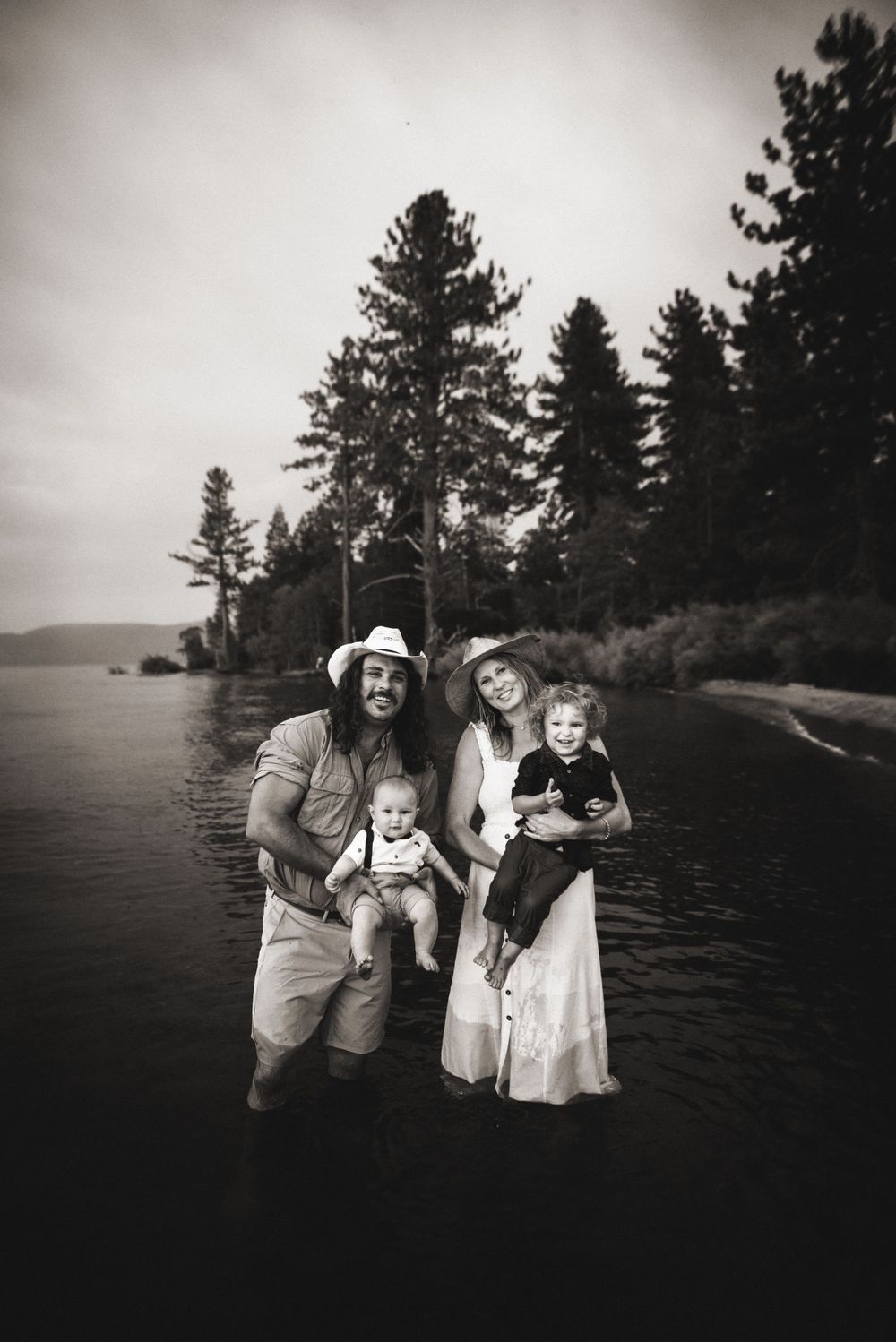 Tahoe family photo session at sunset with parents and children laughing in golden light, captured by Alicia Alvey Photography.
