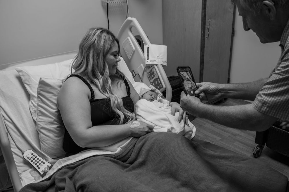 Interior scene showing soft lighting and intimate moments in black and white tones.
