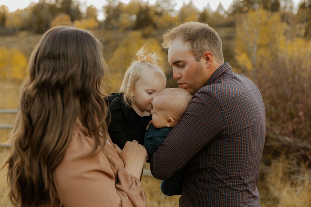 Intimate family moments captured against a backdrop of autumn foliage.